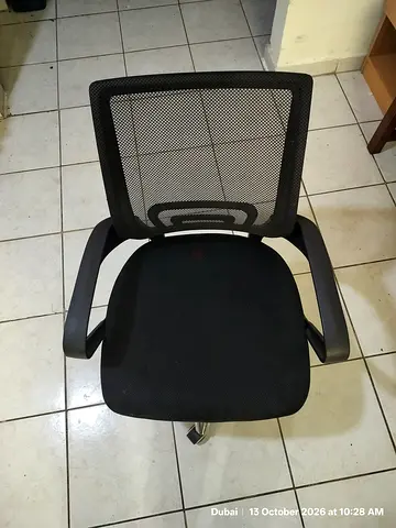 Black mesh office chair with armrests — good condition