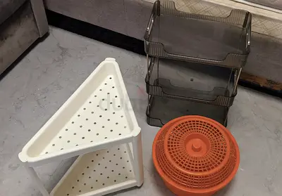 Assorted home organizers: corner shelf, stackable trays
