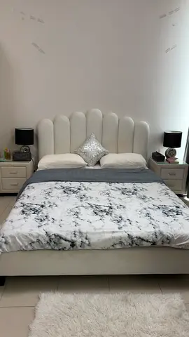 Queen upholstered bed with shell-style headboard and 2 bedside tables and side lamps and mattress