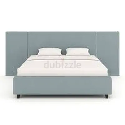 Light blue upholstered double bed with padded headboard