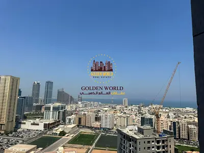 For Annual Rent in Al Majaz 3, a spacious 2-bedroom apartment with a living room and maid’s room, sea view, large kitchen, built-in wardrobes and 3 ba