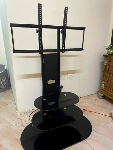 Black glass TV stand with mount and shelves