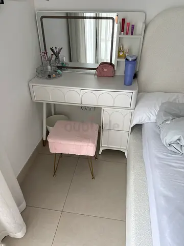 White vanity dressing table with mirror and pink stool