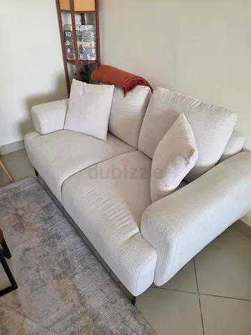 Light beige 2-seater fabric sofa in good condition