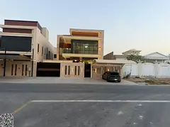 A luxurious European-style villa in Al Rawda 3, featuring two floors and a roof terrace. Located dir