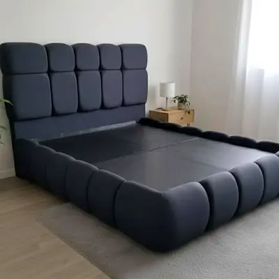 Dark grey upholstered queen bed frame with padded headboard