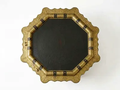 Octagonal Moroccan-style coffee table crafted from wood and metallic-engraved brass panels