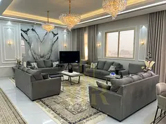 Fully furnished villa in Al Alia, Ajman, with an internal yard. Includes water, electricity, central