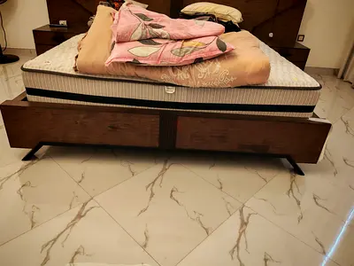 Dark wood queen bed frame with matching bedside table