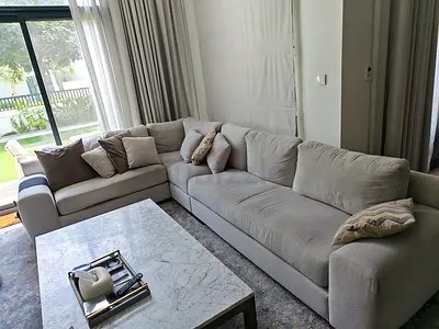 Light beige L-shaped fabric sectional sofa — good condition
