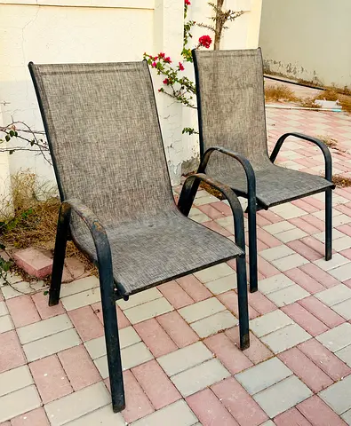 Set of 4 outdoor patio chairs - used, sturdy metal frame with mesh cushion.