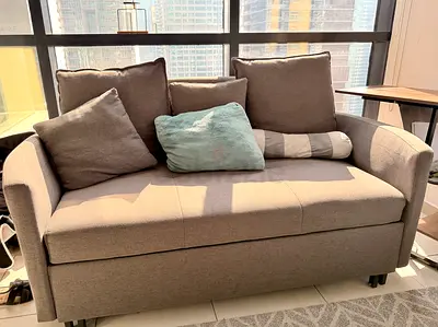Compact 2-seater fabric sofa bed with cushions - good condition