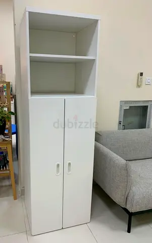 Tall white storage cabinet with shelves and doors