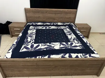 King size wooden bed frame two matching bedside tables and dressing table.