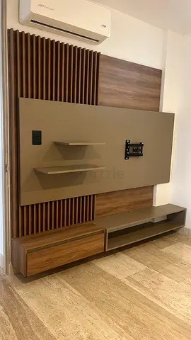 Modern wall-mounted TV unit with shelving and storage