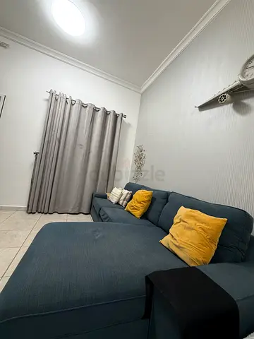 L-shaped fabric sofa (dark blue) in good condition with pillows