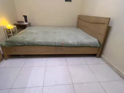 King wooden bed frame with headboard — light oak finish, good condition
