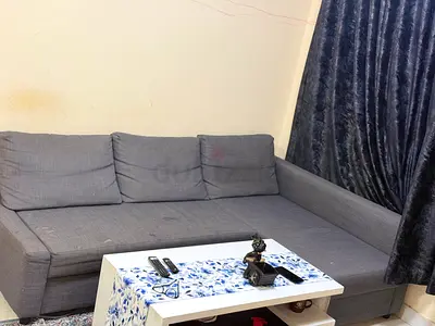 IKEA L-shaped grey fabric sofa with storage chaise used.