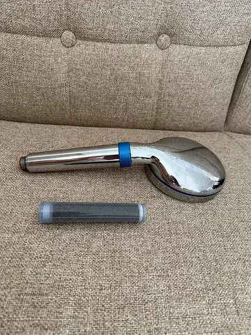 Blue Ionic shower head with replaceable filter - gently used in guest room
