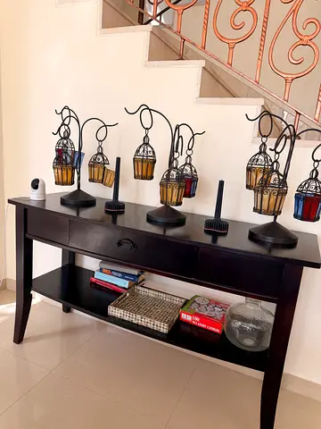 Dark wood console table with decorative candle holders ( 2 in total )