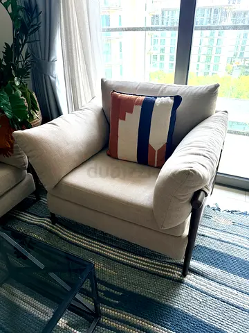 Comfortable single beige armchair with wooden frame. Matching sofa sold separately