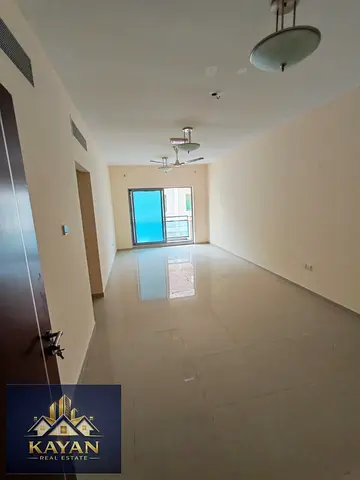 For annual rent: a two-bedroom apartment with a living room in a prime location, opposite Umm Al Quwain Mall.
