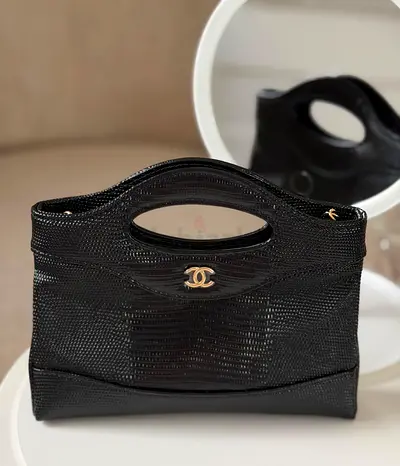 Black textured leather Chanel-style top-handle handbag with gold logo