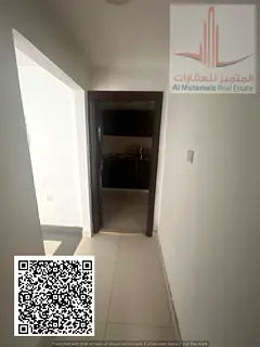 One-bedroom apartment with a living room for rent in Al Nuaimiya 2; features a balcony and central a