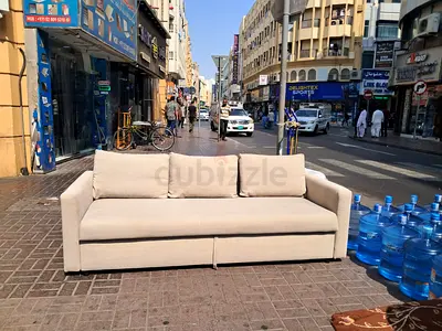 Light beige three-seat sofa with storage - good condition