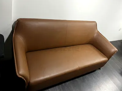 Genuine leather 2-seater sofa in tan — good condition