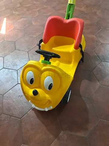 Yellow ride-on push car for toddler with parent handle — good condition