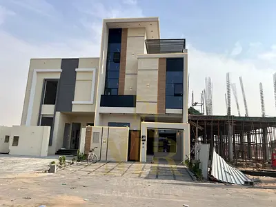 Luxury modern villa for sale in Al Helio 1 – Ajman | Two floors plus a roof terrace | Near Safeer Mall | Opposite amenities | Registration and ownersh