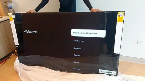 Brand new flat panel TV — still in protective film, 55-65 inch (unused). Bought the wrong size hence