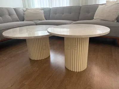 Pair of round marble-top coffee tables with fluted column bases