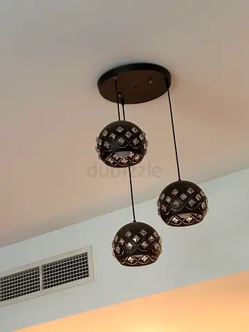 Three-head decorative table lamp with cut-out metal shades