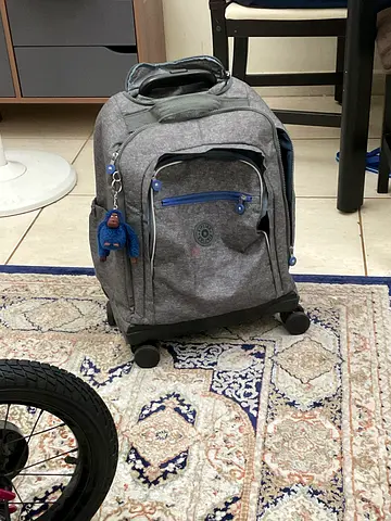 Grey rolling backpack with telescopic handle and wheels - good condition