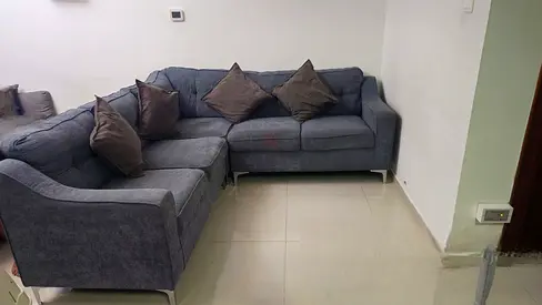 L-shaped grey fabric sofa (5-seater) with cushions - good condition