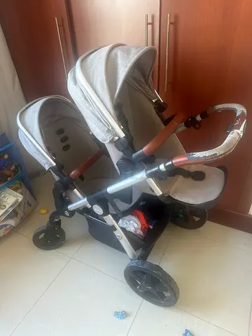 Double/twin stroller - used, sturdy frame with storage basket. Newborn Bassinet available also.