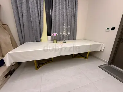 Large rectangular dining table with gold metal legs - modern design