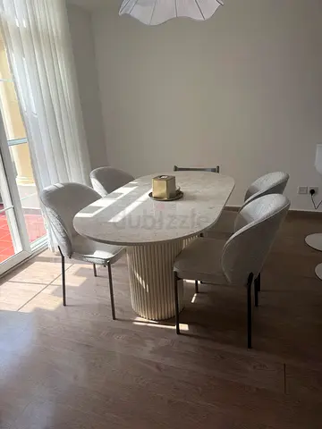 Custom made marble-top dining table with four upholstered chairs