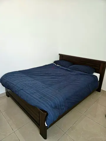 Queen size bed frame with mattress and pillows