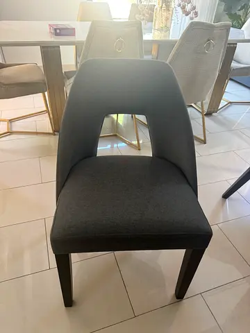 Modern upholstered dining chair with cut-out back, dark grey