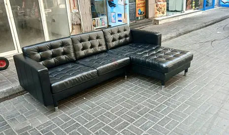 Black L-shaped tufted leather sofa - right chaise, good condition