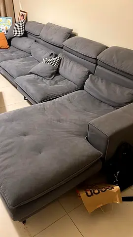 Large grey suede L-shaped sectional sofa with adjustable headrests