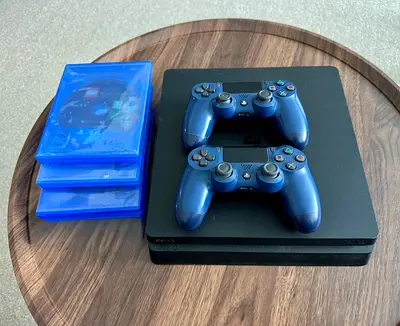 PlayStation 4 Slim with 2 DualShock Controllers and 3 Games - Good Condition