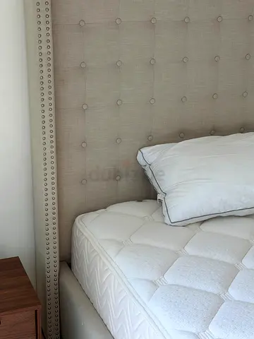 Beige tufted headboard with mattress — good condition