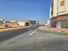 Residential-commercial land for sale in the Emirate of Ajman, Al Zahia area, located directly on She