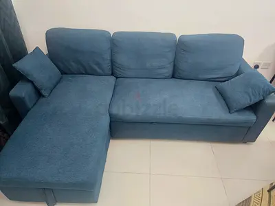 Blue L-shaped storage sofa with removable cushions — good condition