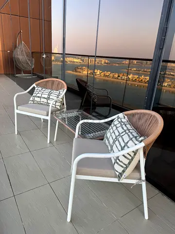 Pair of outdoor patio lounge chairs with cushions