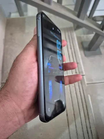 Used smartphone in good condition - shows working display and buttons